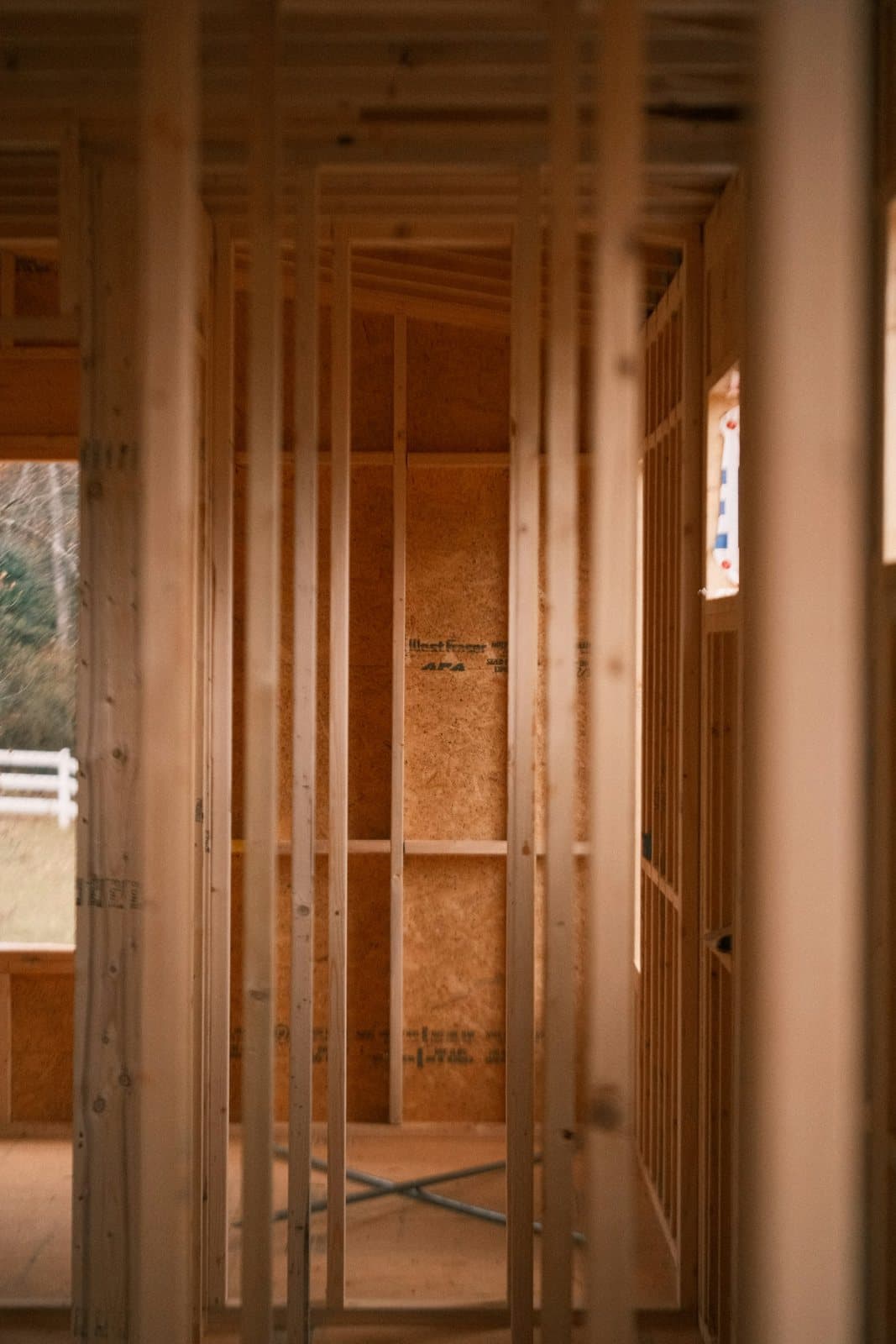 Looking through new timber wall frames inside a house being built